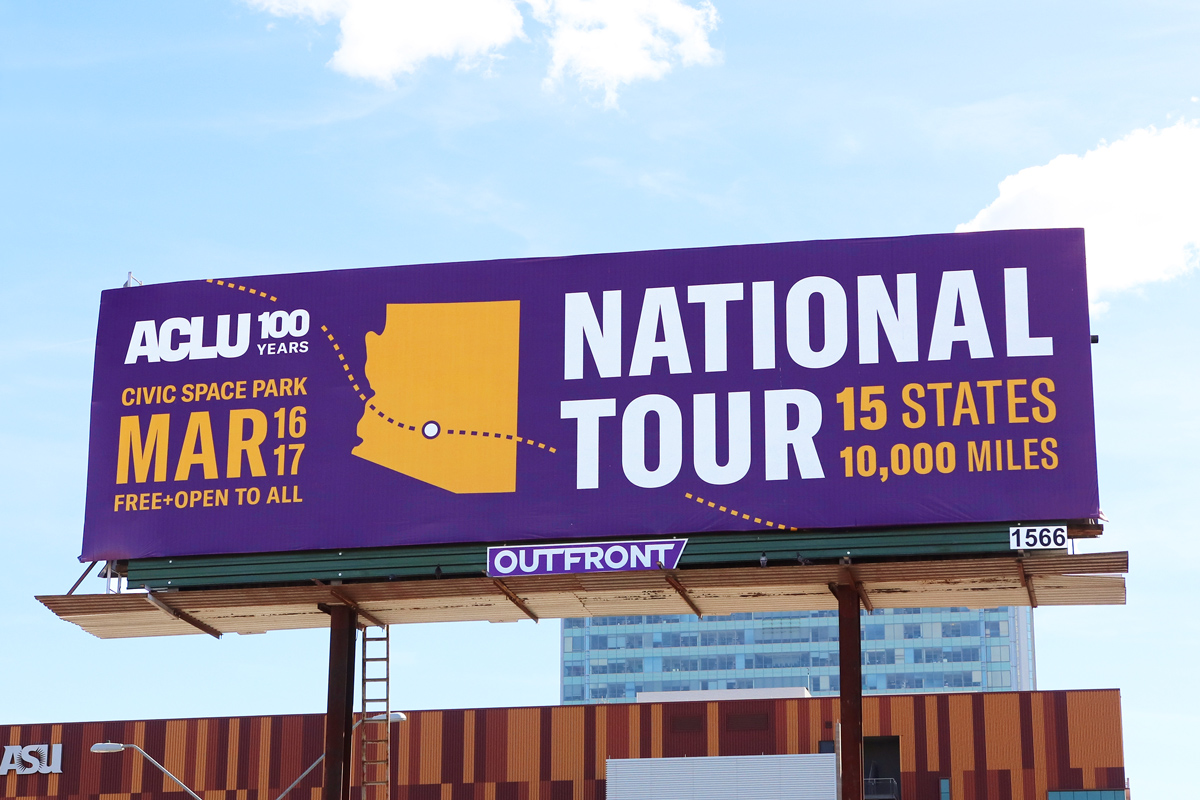 A billboard with an ad for the tour. It reads "National tour, 15 states, 10,000 miles" in large text, along with the date and location. It has the shape of Arizona, with a dotted line leading in and out of Phoenix to signify the tour route.