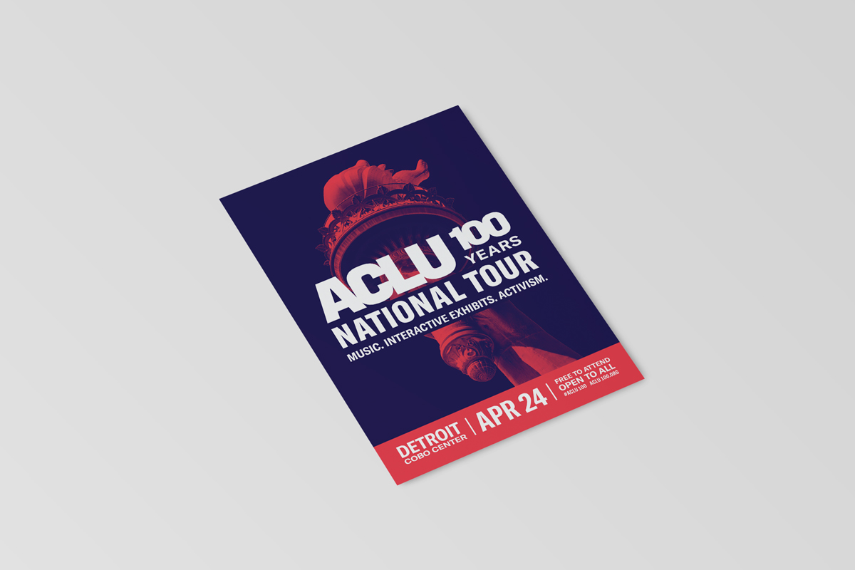 A mockup of a postcard-sized flyer for the Detroit stop of the tour. It shows the same duotone image of the statue of liberty torch, this time in red on a navy blue background, with the tour logo across it and the event info at the bottom.